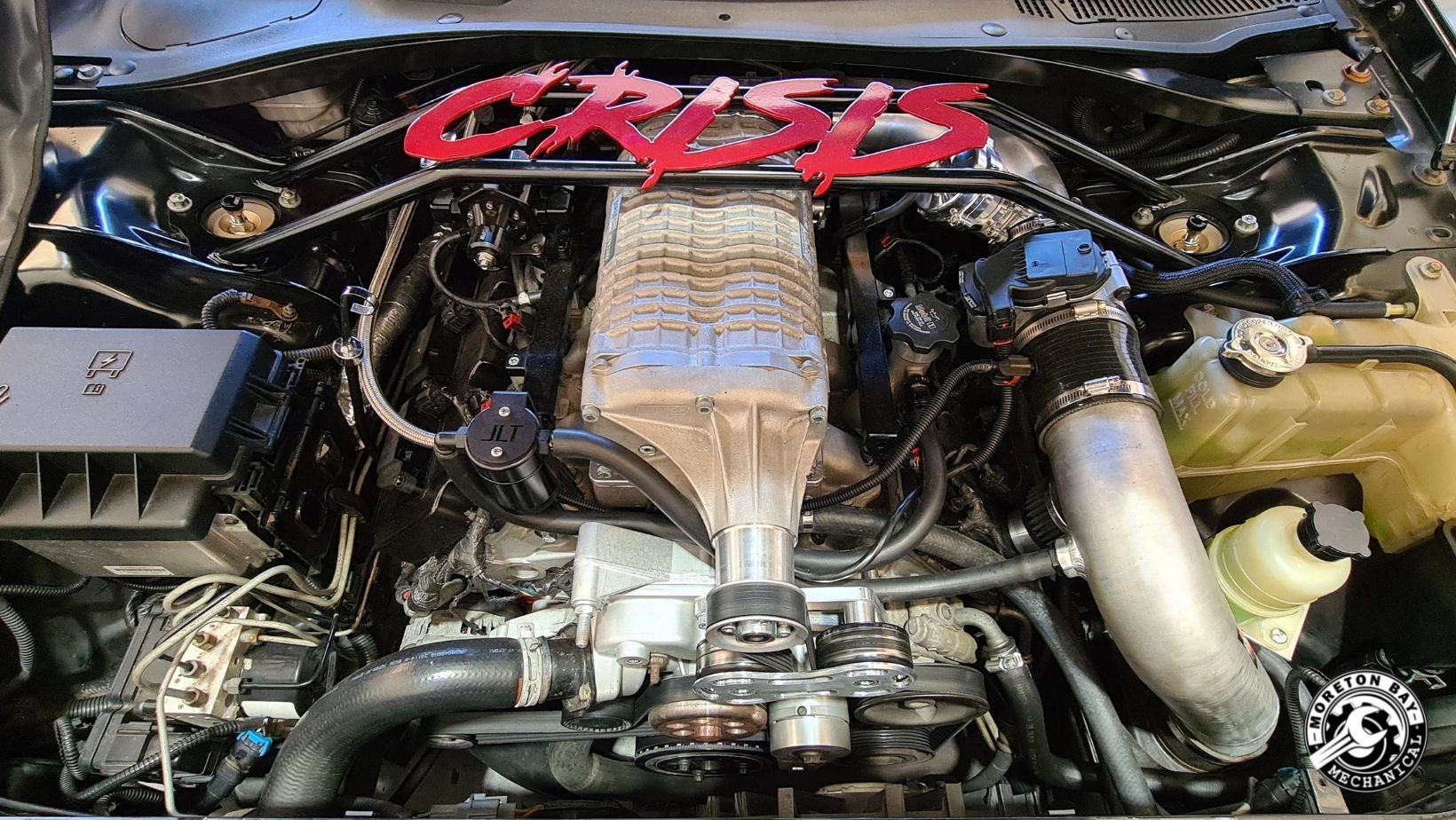 Supercharged performance engine bay under the bonnet in the workshop